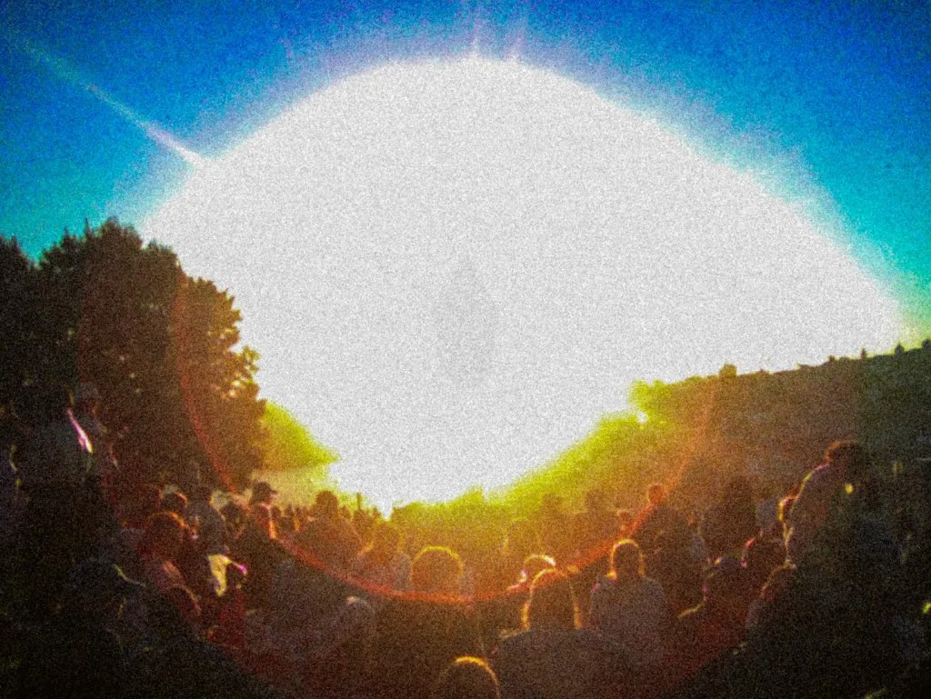 Crowd under sun banner